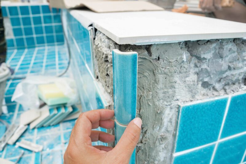 Why You Should Start Building Your Pool In The Fall installation of tiles in swimming pool construction.construction