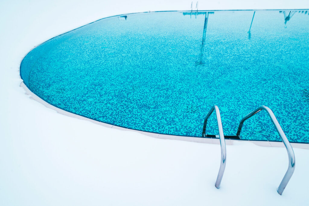 Getting Your Pool Ready For Snow And Ice swimming pool with snow during winter