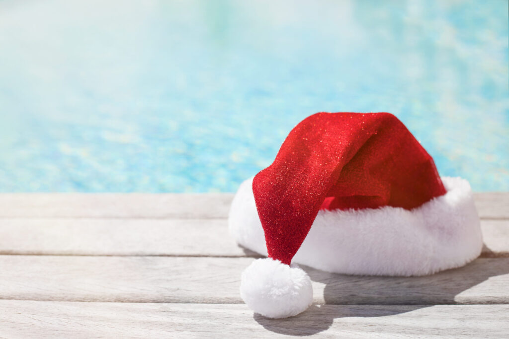 Throw a Holiday Party at your Pool/Backyard Resort red santa hat by the pool